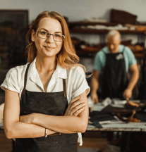 Business owner standing confidently in front of the camera.